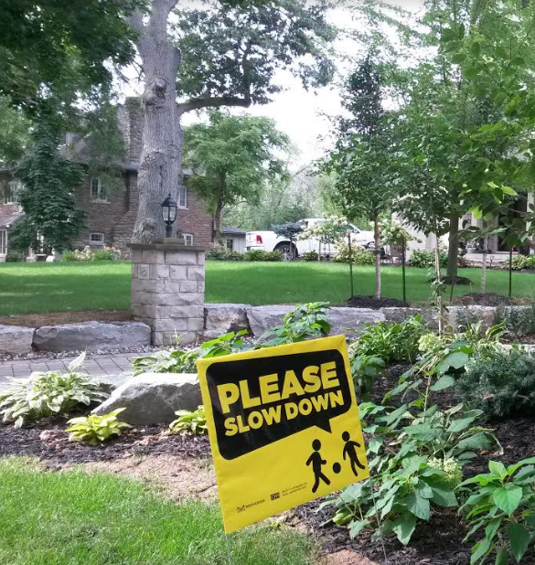 A sign asking drivers to slow down is seen on Stavebank Rd. just north of the Port Credit GO station. (Photo: Kelly Roche/QEW South Post)
